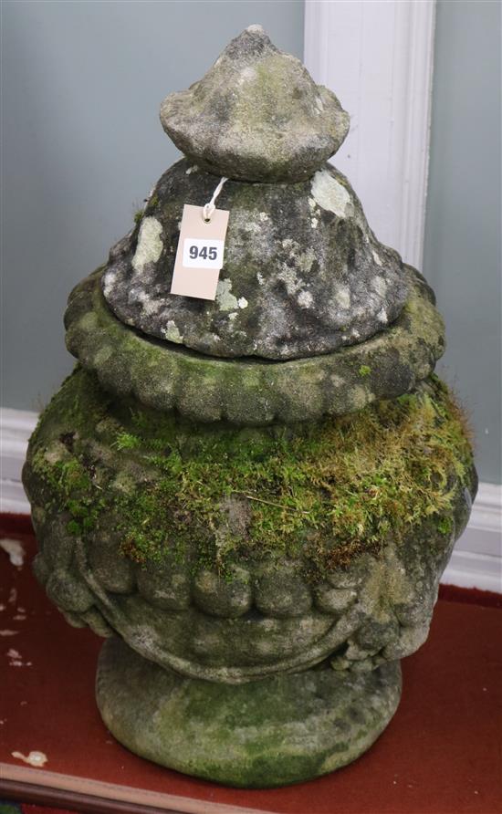 A pair of weathered composition garden urns and covers, H.2ft 1in.